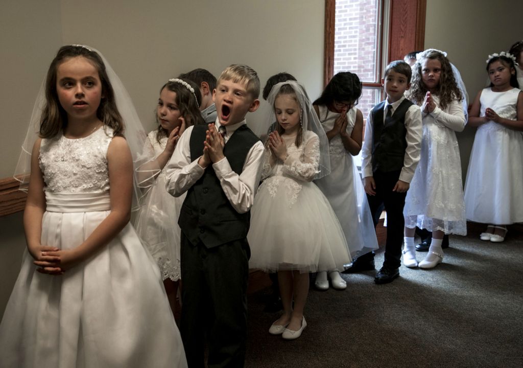 First place, Photographer of the Year - Small Market - Jessica Phelps / Newark AdvocateStudents of St. Francis De Sales in Newark, Ohio line up in the hall of their school waiting to enter the church for their First Communion on May 4, 2019. 