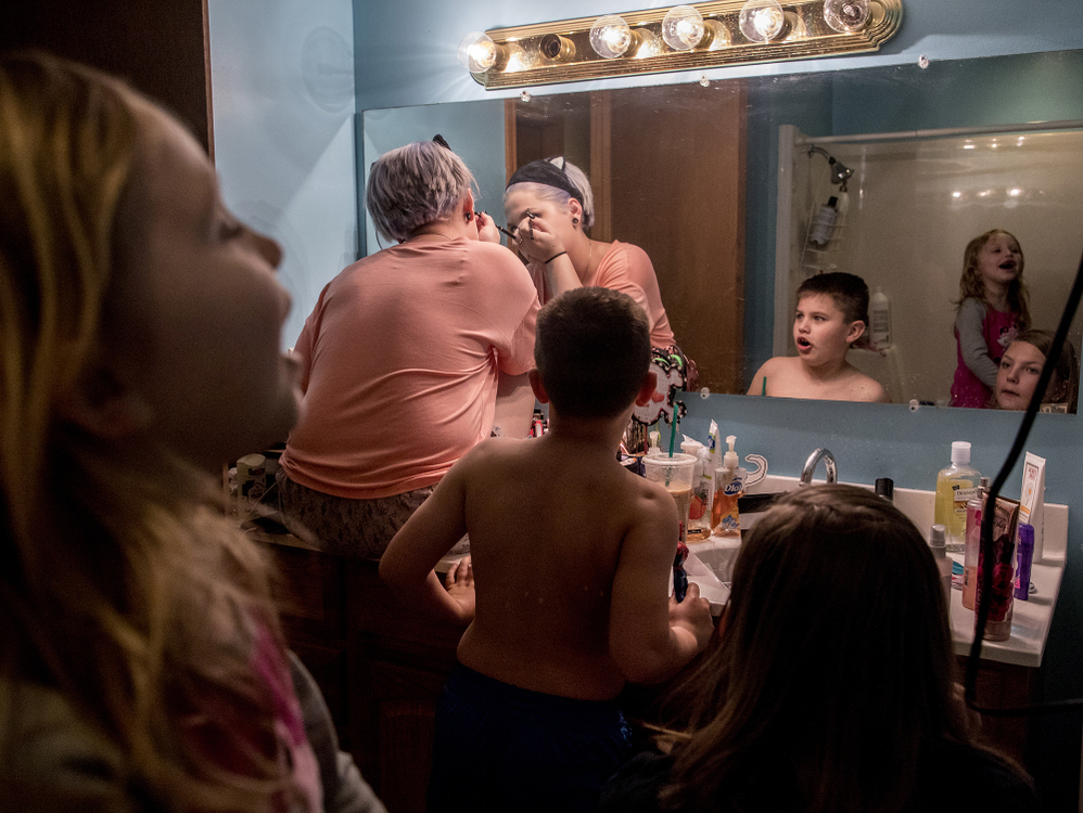 First place, Photographer of the Year - Small Market - Jessica Phelps / Newark AdvocateSeated in the sink of the bathroom she shares with her sister, Jazmin calmly applies her make-up for prom while her younger siblings Jenna, Kyle and Tori wreak havoc in the bathroom around her, May 4, 2019. 