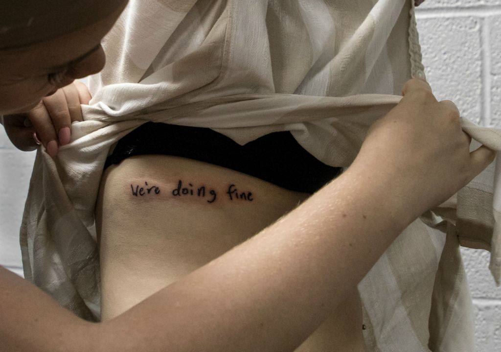 First place, Photographer of the Year - Small Market - Jessica Phelps / Newark AdvocateJazmin shows off a tattoo she had gotten earlier in the day to her friends while they prepare in the dressing room for their final play for their high school drama class, May 24, 2019. Drama and art, along with strong relationships with her friends, many of whom are in the drama program, have helped Jazmin deal with the grief of losing both parents two years prior. 