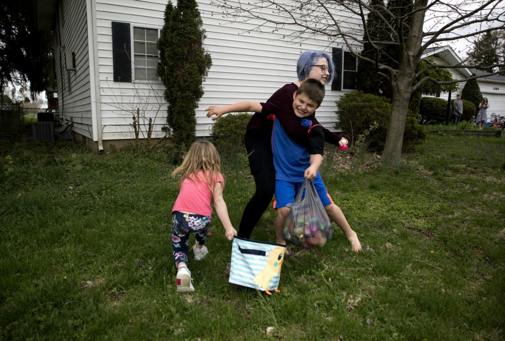 First place, Photographer of the Year - Small Market - Jessica Phelps / Newark AdvocateDuring an Easter egg hunt at their Newark home in May,  2019, Jazmin playfully holds off her brother Kyle so their younger sister, Tori can pick up the egg and add it to her collection. All three siblings and their sister Jenna (not pictured) were in the car with their mom almost two years ago when they were struck by another vehicle. Jazmin pulled her siblings to safety but cold not save their mother, who died at the scene. 