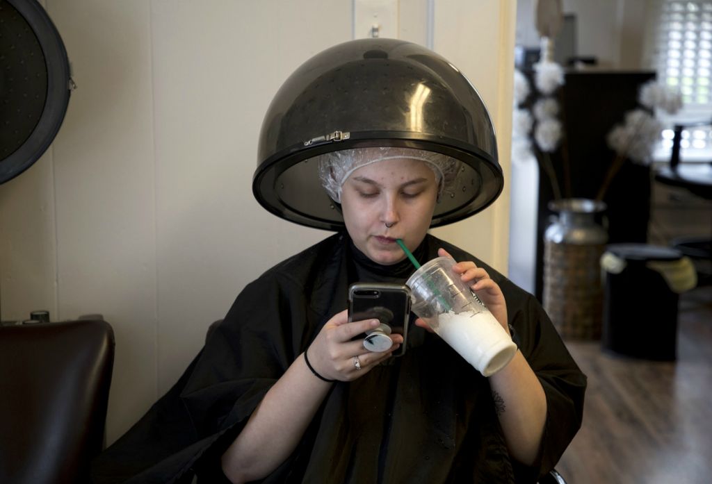 First place, Photographer of the Year - Small Market - Jessica Phelps / Newark AdvocateJazmin sits under the dryer at the hair salon owned by Paulette Muncy who has cut Jazmin's hair since she was in elementary school. Jazmin was getting her hair dyed violet in April, 2019 ahead of her upcoming prom and graduation.