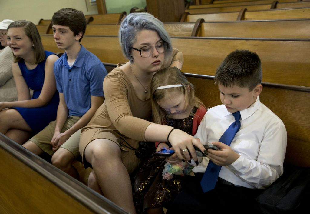 First place, Photographer of the Year - Small Market - Jessica Phelps / Newark AdvocateFamily has always been important to Jamzin Harkin. May 4, 2019, the morning of her senior prom Jazmin went to church to watch her brother, Kyle receive his first communion instead of spending the day in a salon like many of her friends. Before the ceremony started she helped keep Kyle and their sister, Tori, entertained and under control. 