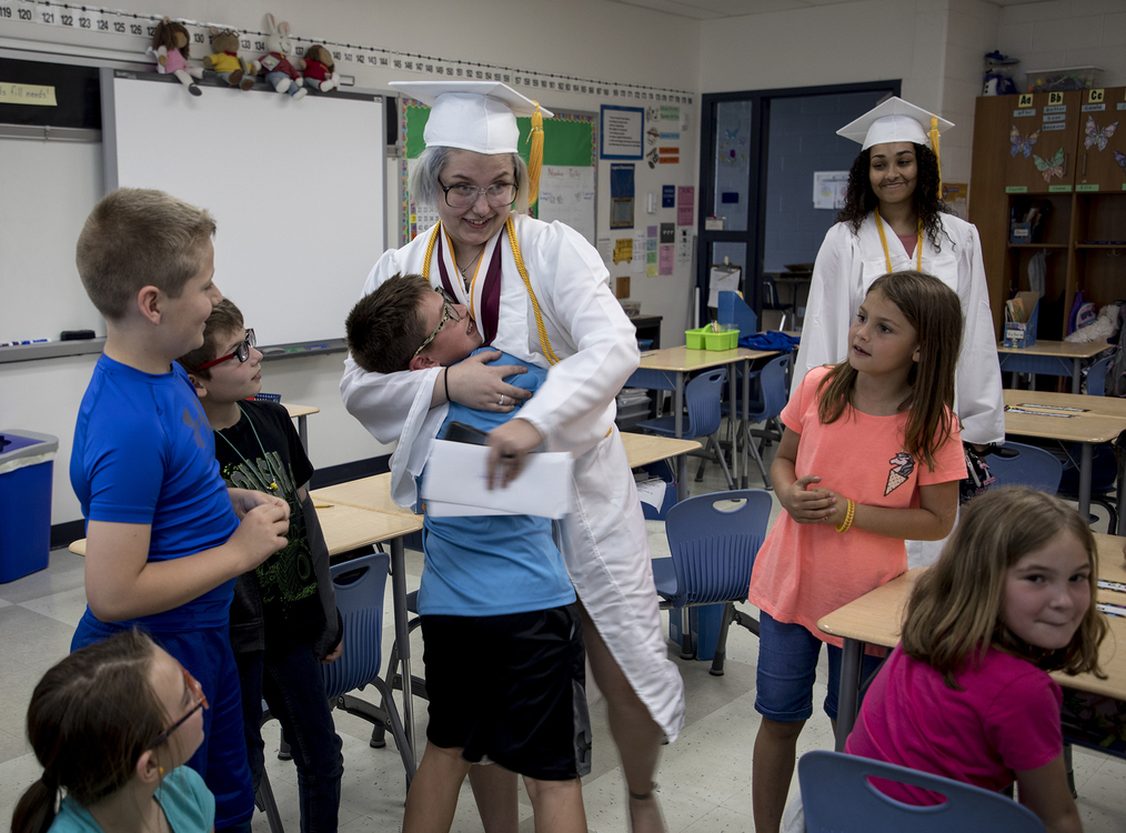 First place, Photographer of the Year - Small Market - Jessica Phelps / Newark AdvocateJazmin Harkin hugs her little brother Kyle in his classroom at Legend Elementary, May 23, 2019. Jazmin and other Newark High School graduates did a walk through of their old schools to inspire younger students. The visit was a surprise to Kyle, who hasn't been able to come to terms with the fact that his big sister will be leaving for college in the fall. 