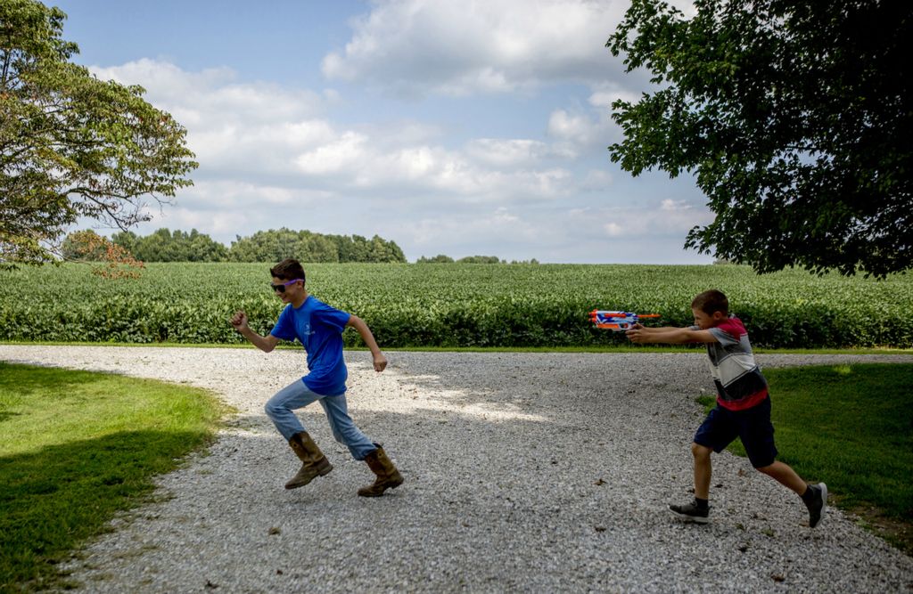 First place, Photographer of the Year - Small Market - Jessica Phelps / Newark AdvocateArthur and Bryce Hollenback have learned responsibility from a young age while also gaining independence that comes with growing up on a farm. The boys live on the farm with their parents Andy and Mamie who bought it just before Arthur was born and there is nothing Andy Hollenback would rather be than a farmer. "It's hard work, it's hot, it's dusty, it's unforgiving. But through all of that, man I love it."  For the Hollenbacks it's not just a business. It's a way of life and a legacy for their children. Brothers Arthur and Bryce Hollenback chase each other around their yard with Nerf guns on a warm August  evening in 2018. The boys can usually be found outside exploring or building things like dams or forts, or playing with their Nerf guns. Growing up on a family farm in rural Ohio offers a freedom to the Hollenback boys while also instilling in them a sense of self pride and responsibility. Story published January 12, 2019