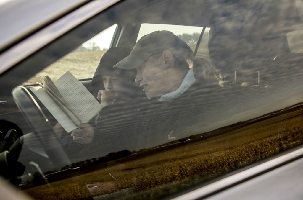 First place, Photographer of the Year - Small Market - Jessica Phelps / Newark AdvocateMamie Hollenback reads 'Island of the Blue Dolphins' in the car with Bryce in early November, 2019, while waiting for the bus to arrive. Mamie wants to make sure there is time for reading with her sons, but faming life is busy so they fit it in whenever they can. 