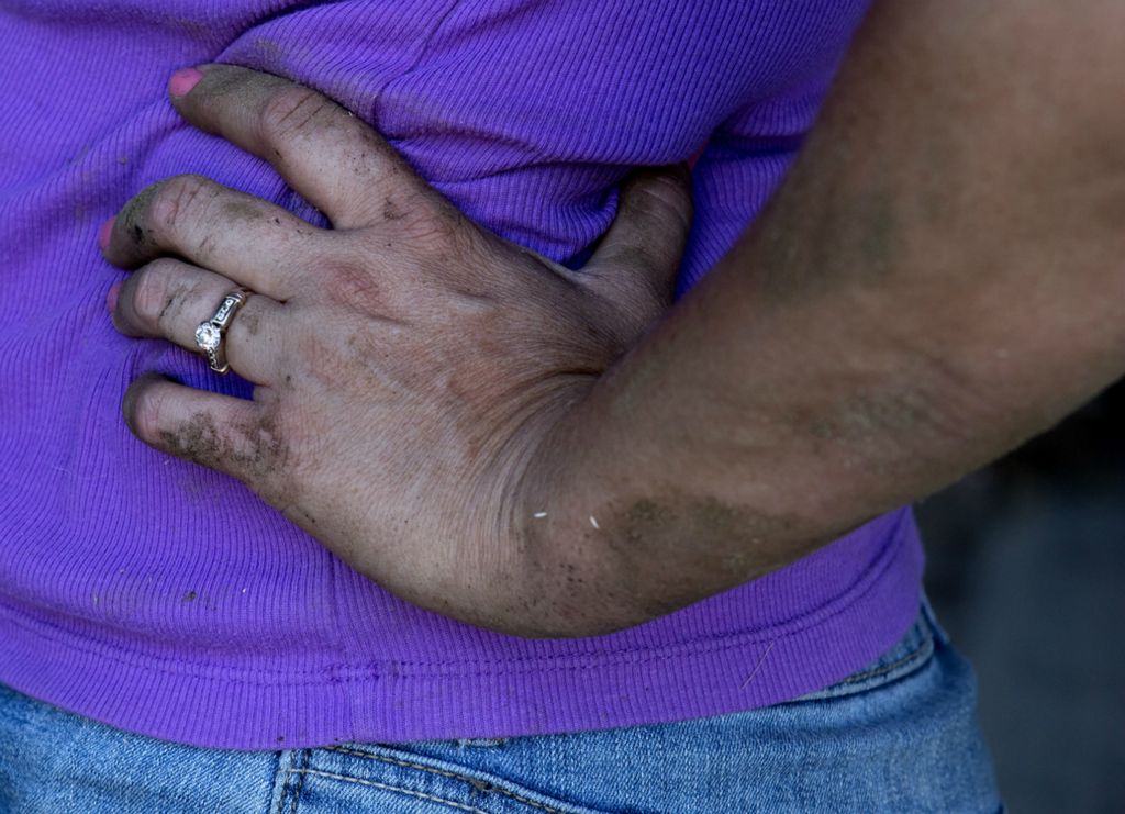 First place, Photographer of the Year - Small Market - Jessica Phelps / Newark AdvocateFaming is hard and often dirty work, but Mamie Hollenback and her husband Andy wouldn't change a thing. They love the life and the work and how it is shaping the lives of their two sons. Mamie addresses the constant mud with little feminine touches like pink nail polish, July 18, 2018. 