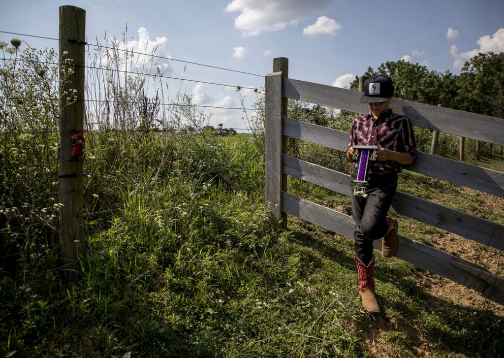 First place, Photographer of the Year - Small Market - Jessica Phelps / Newark AdvocateBryce Hollenback proudly stands against a fence outside the family cow barn holding his trophy he won at the Knox County Fair for Reserve Grand champion for the feeder calf class earlier that day, July 26, 2019. Growing up on the farm has taught Bryce responsibility but also allowed him the freedom to roam outside in a way that many kids don't experience anymore. 