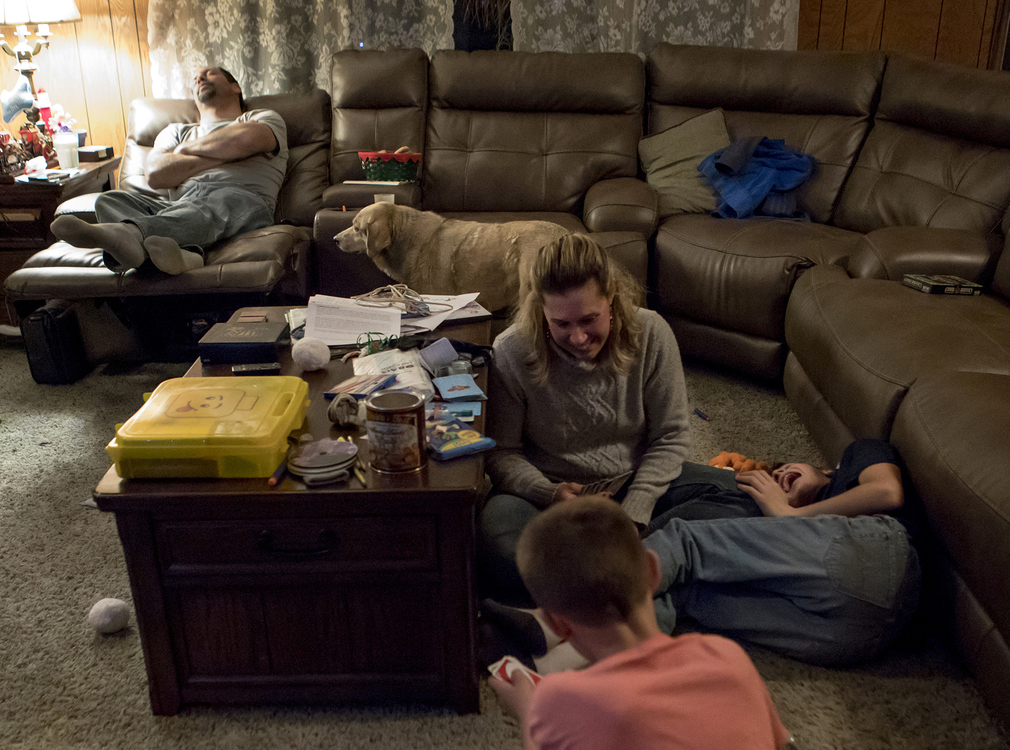 First place, Photographer of the Year - Small Market - Jessica Phelps / Newark AdvocateMamie Hollenback plays a rowdy game of uno with sons Arthur and Bryce while her husband, Andy sleeps on the recliner behind them, December 14, 2018. The family had just finished harvesting the last of their crops, much later than most years due to heavy rains. Usually the family is finished around Thanksgiving but this year they worked through mid December. 