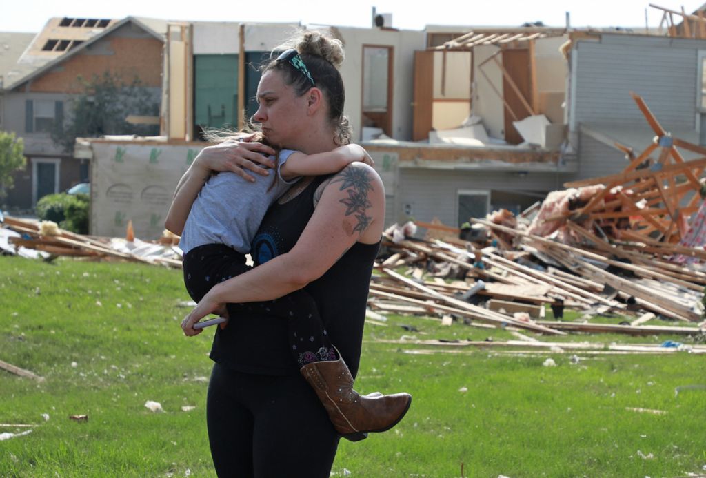 Second Place, Photographer of the Year - Small Market - Bill Lackey / Springfield News-SunMeghan Porter holds her frightened daughter, Gemma, 6, as they walk through their destroyed Beavercreek neighborhood. A series of overnight tornados destroyed hundreds of homes in the Dayton and surrounding areas. 