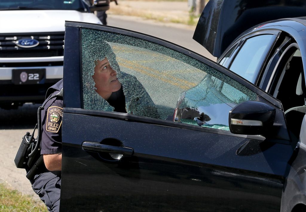 Second Place, Photographer of the Year - Small Market - Bill Lackey / Springfield News-SunA Springfield Police officer is seen through the shattered window of a car that was traveling east of West Main Street when the driver was shot in the arm by the driver of another car. The bullet traveled through the drivers arm and shattered the passenger window. Police are still looking for the shooter. 