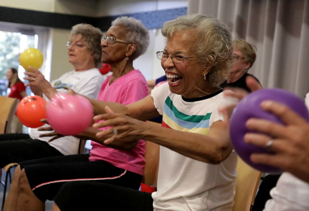 Second Place, Photographer of the Year - Small Market - Bill Lackey / Springfield News-SunVarga Berrien laughes as she does aerobics for seniors with a group on stage Tuesday at the Community Health Foundation's annual Health Expo at the Hollenbeck Bayley Conference Center.