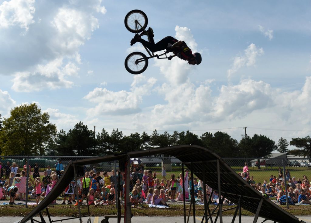 Third Place, Photographer of the Year - Small Market - Erin Caldwell / Sandusky RegisterEdison Elementary students watch as BMX Pros' Dallas Weimer flips through the air during a performance on Oct. 1, 2019, in Milan.