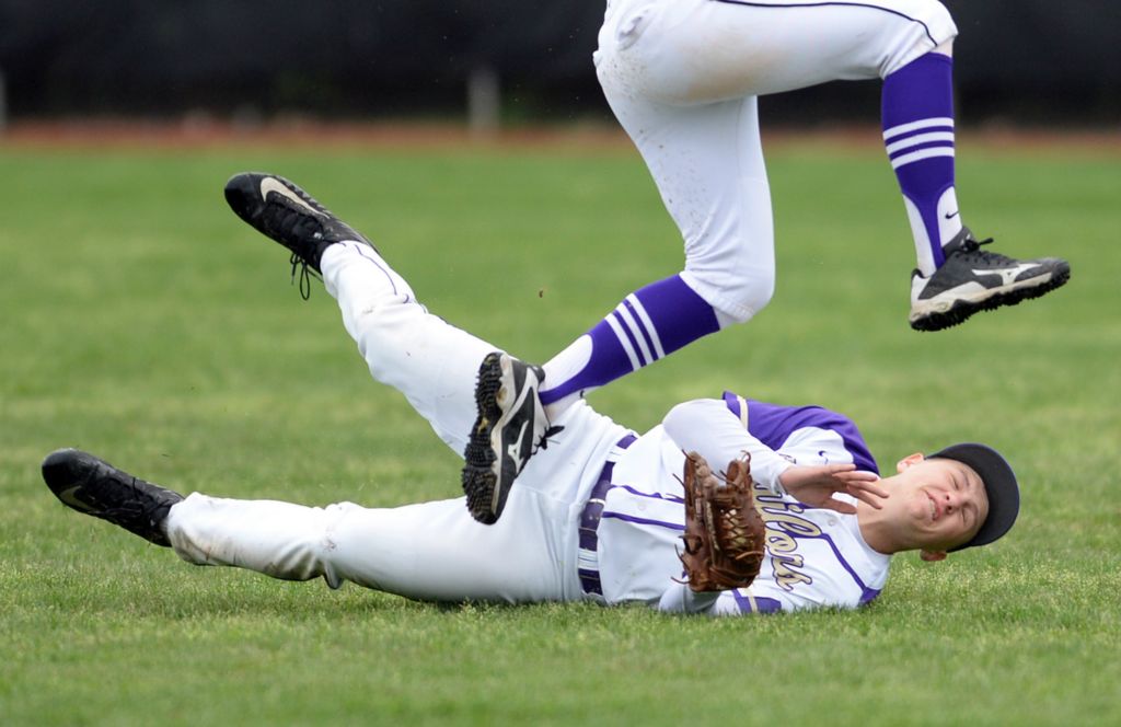 Third Place, Photographer of the Year - Small Market - Erin Caldwell / Sandusky RegisterVermilion's Ethan Young dives to catch the ball as his teammate, Sam Herron, jumps over Young during a game against Edison at Oberlin College on Friday, May 3, 2019.