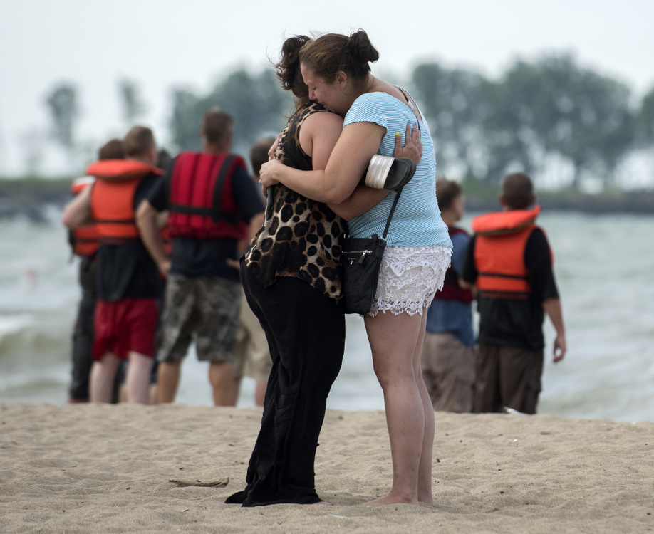 Third Place, Photographer of the Year - Small Market - Erin Caldwell / Sandusky RegisterTwo women console each other at Nickel Plate Beach in Huron after a woman went missing in the water on Sunday, July 21, 2019. The woman's body was discovered about two miles east of the beach on Thursday, July 25. It was the second drowning to occur at Nickel Plate Beach within two weeks.