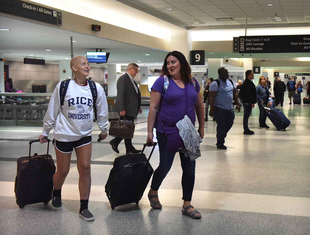 Third Place, Photographer of the Year - Small Market - Erin Caldwell / Sandusky RegisterCam and her mother, Aimee, walk through baggage claim at Cleveland Hopkins International Airport after arriving back from Houston on April 11, 2019. Cam traveled to Houston for several weeks to receive proton therapy, which is a more direct form of radiation.