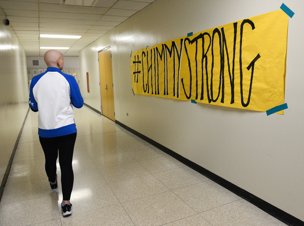 Third Place, Photographer of the Year - Small Market - Erin Caldwell / Sandusky RegisterWhile walking down the hallway at Vermilion High School, Cam looks at a sign hanging on the wall with her hashtag #CHIMMYSTRONG. Chimmy was a nickname given to Cam by her father.