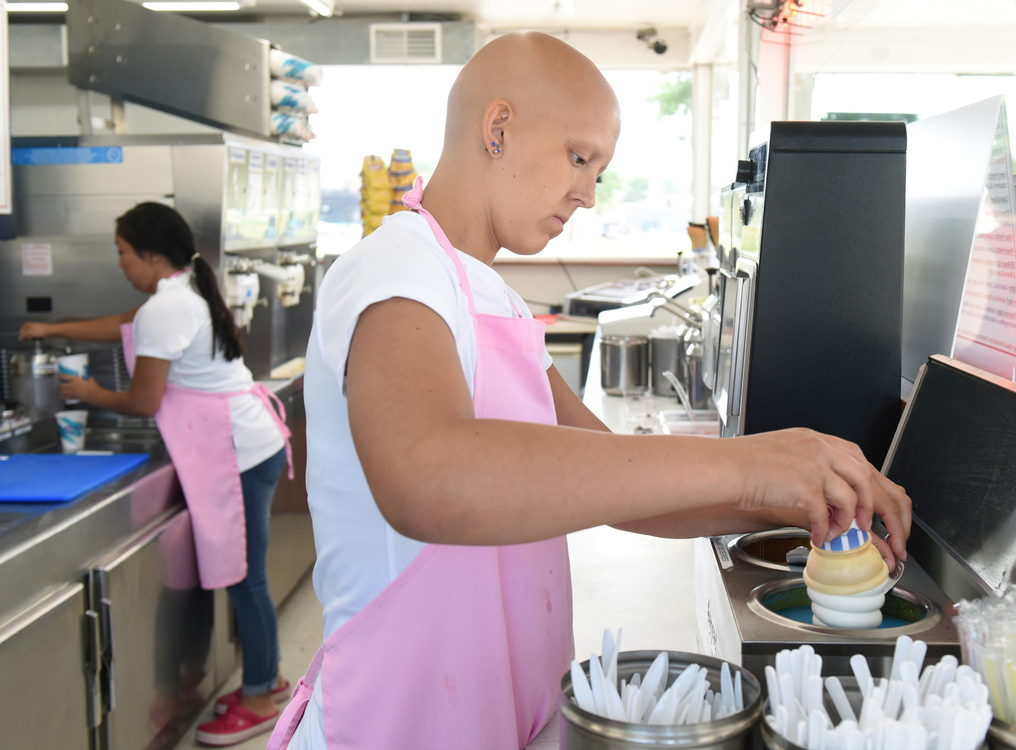 Third Place, Photographer of the Year - Small Market - Erin Caldwell / Sandusky RegisterCam dips an ice cream cone while working at Romp's Dairy Dock in Vermilion on July 21, 2019. While receiving treatment, Cam still worked a couple days a week at the ice cream stand.