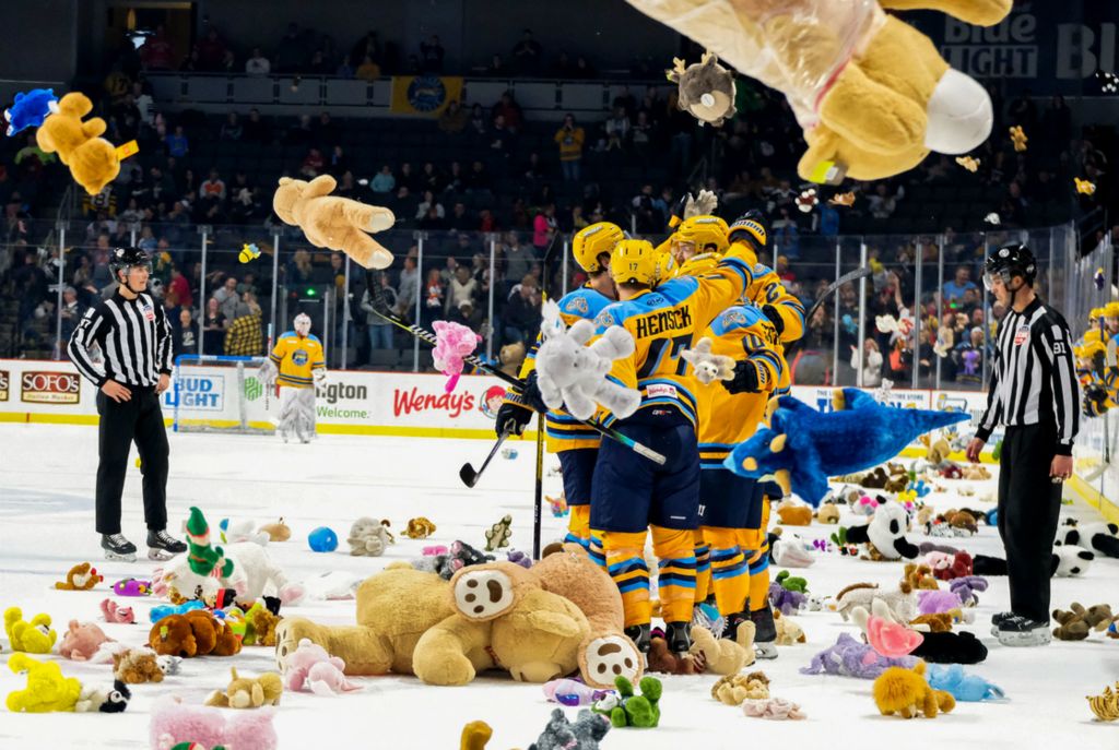 Second Place, Sports Feature - Kurt Steiss / The Blade, “Teddy Bear Toss”Walleye players celebrate their first goal of the game as stuffed animals are thrown on the ice for the teddy bear toss during an ECHL hockey game against the Cincinnati Cyclones at the Huntington Center in Toledo on Dec. 7, 2019. The stuffed animals thrown on the ice were collected and distributed to area organizations. 