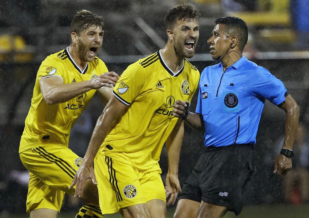 First Place, Ron Kuntz Sports Photographer of the Year - Kyle Robertson / The Columbus DispatchColumbus Crew SC defender Alex Crognale (21) yells at referee Guido Gonzales Jr. after David Accam was taken down in the final seconds of the game and no call was made against Atlanta United during the second half in an U.S. Open Cup game at MAPFRE Stadium in Columbus, Ohio on June 18, 2019. Crew SC lost 3-2 to Atlanta.