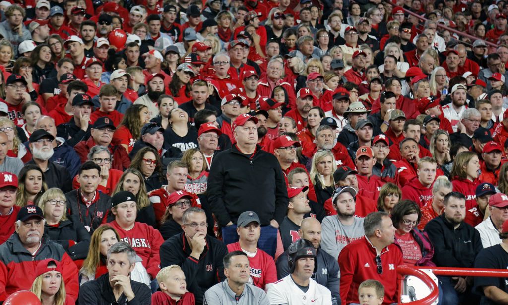 First Place, Ron Kuntz Sports Photographer of the Year - Kyle Robertson / The Columbus DispatchA lone Nebraska Cornhuskers fan stands up alone in disbelief after Ohio State Buckeyes scored a rushing touchdown to make it 31-0 early in the 2nd quarter of their game at Memorial Stadium in Lincoln, Neb. on September 28, 2019. 
