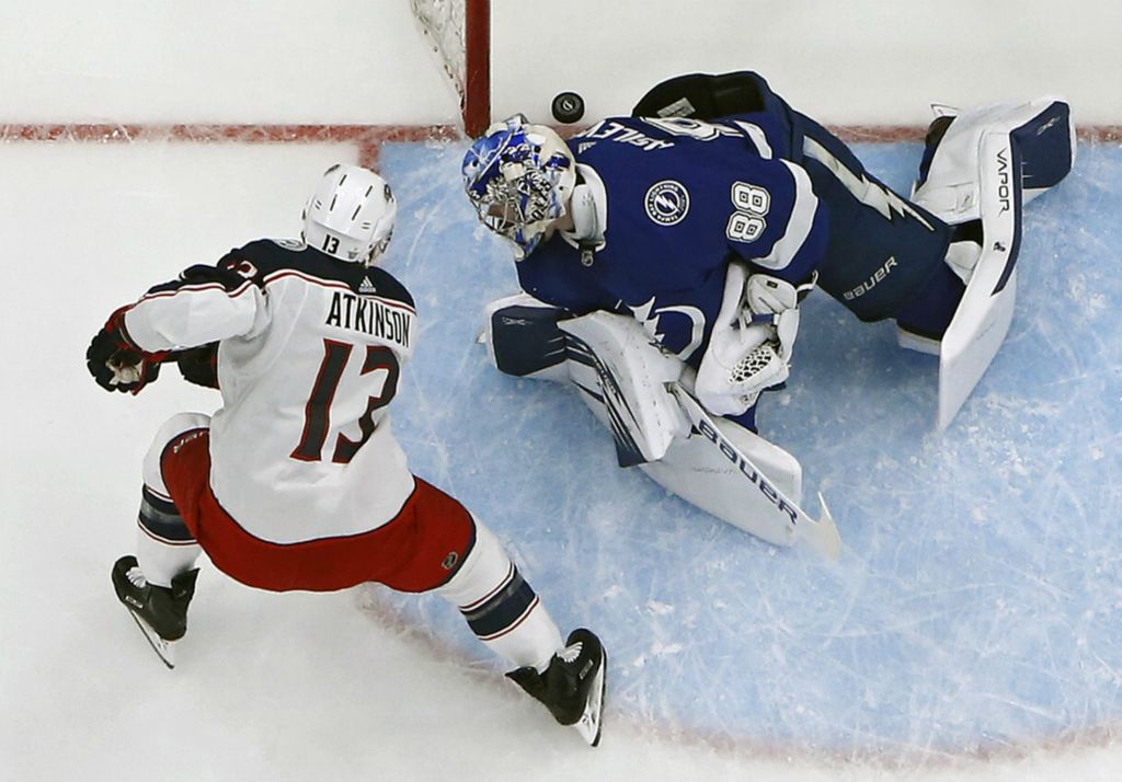 First Place, Ron Kuntz Sports Photographer of the Year - Kyle Robertson / The Columbus DispatchColumbus Blue Jackets right wing Cam Atkinson (13) scores on Tampa Bay Lightning goaltender Andrei Vasilevskiy (88) during the 1st period in Game 2 of the first round of the NHL Stanley Cup Playoffs at Amalie Arena in Tampa, Florida on April 12, 2019. 