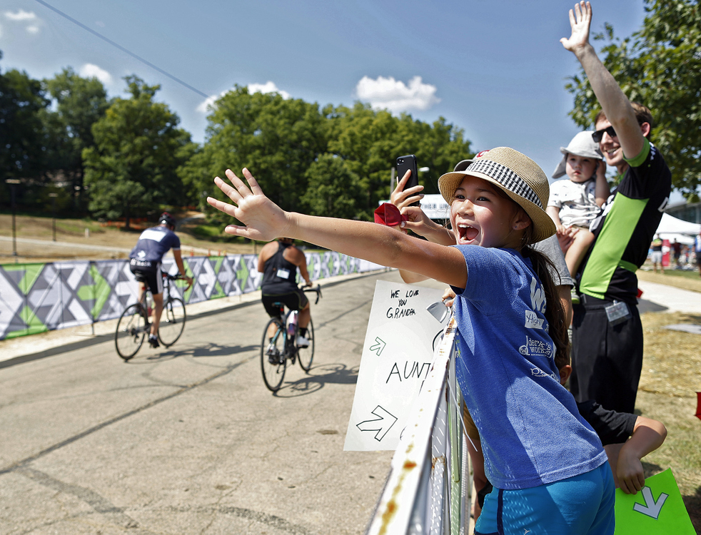 First Place, Ron Kuntz Sports Photographer of the Year - Kyle Robertson / The Columbus DispatchEllie Brasky, 9, and her little brother Nate, 6, (behind) cheer as their father Ted heads towards the finish line at Kenyon College during the 11th Pelotonia in Gambier, Ohio on August 3, 2019. 