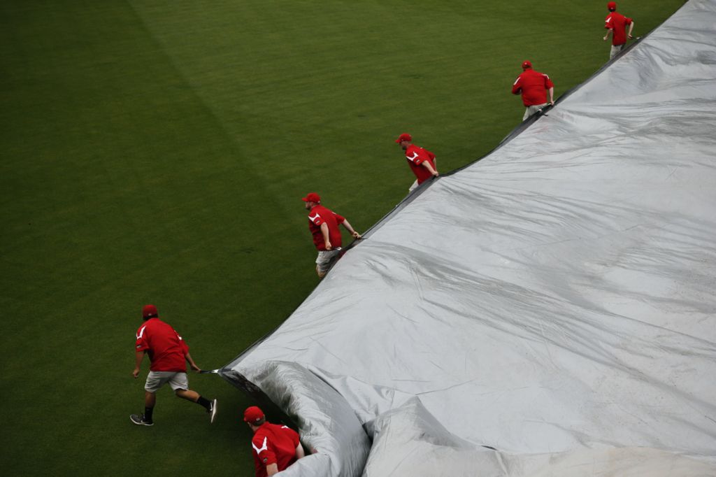Second Place, Ron Kuntz Sports Photographer of the Year - Joshua A. Bickel / The Columbus DispatchGrounds crewmen remove a rain tarp before the start of play during an International League baseball game between the Columbus Clippers and the Toledo Mud Hens on Thursday, May 23, 2019 at Huntington Park in Columbus, Ohio.  Heavy rains swept through the area Thursday morning, but cleared in time for first pitch.