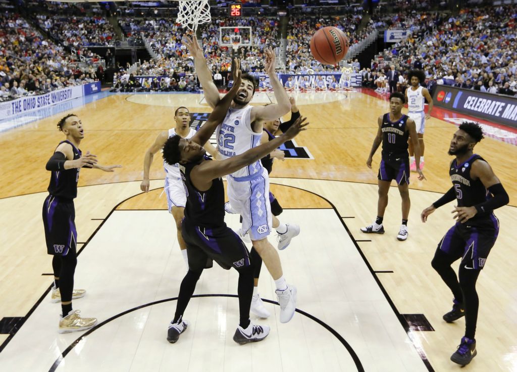 Second Place, Ron Kuntz Sports Photographer of the Year - Joshua A. Bickel / The Columbus DispatchWashington Huskies forward Noah Dickerson (15) fouls North Carolina Tar Heels forward Luke Maye (32) as he drives to the basket during the first half of a NCAA Division I Men's Basketball Tournament second round game between the North Carolina Tar Heels and the Washington Huskies on Sunday, March 24, 2019 at Nationwide Arena in Columbus, Ohio.