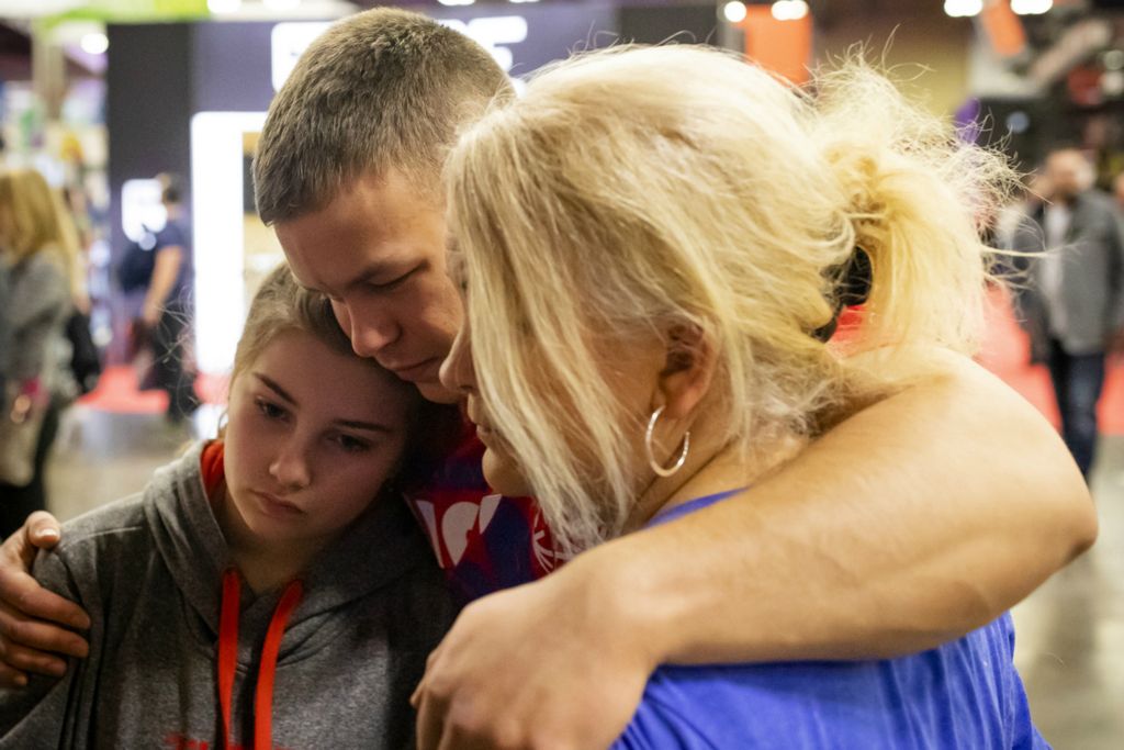 Second Place, Ron Kuntz Sports Photographer of the Year - Joshua A. Bickel / The Columbus DispatchAfter getting into a brief argument with his stepsister, Grace, left, Garrett Ford embraces her and his mother, Leah, right, to apologize while at the Arnold Sports Festival on Sunday, March 3, 2019 at the Greater Columbus Convention Center in Columbus, Ohio. "Family is hugely important to Garrett," Leah Yost said. "He's definitely a peacemaker."
