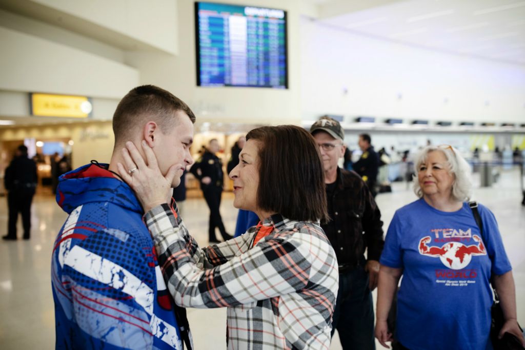 Second Place, Ron Kuntz Sports Photographer of the Year - Joshua A. Bickel / The Columbus DispatchGarrett's grandmother Jackie Mossman says goodbye as he leaves to board his flight to Newark en route to Abu Dhabi for the Special Olympics World Games on Wednesday, March 6, 2019 at John Glenn International Airport in Columbus, Ohio. During the competition, Garrett swept his events, winning gold in the deadlift, squat, bench press and the overall competition. Following this performance, Garrett plans to compete among his able-bodied peers.