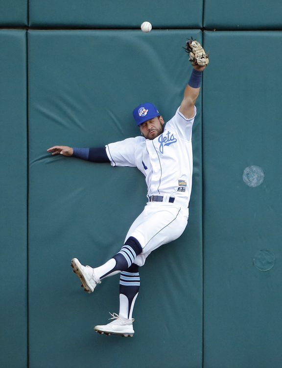 Third Place, Ron Kuntz Sports Photographer of the Year - Adam Cairns / The Columbus DispatchColumbus Clippers right fielder Ka'ai Tom (1) leaps but can't come up with the catch off the bat of Louisville Bats first baseman Nick Longhi (22) during the Minor League Baseball game at Huntington Park in Columbus on Wednesday, July 31, 2019. 