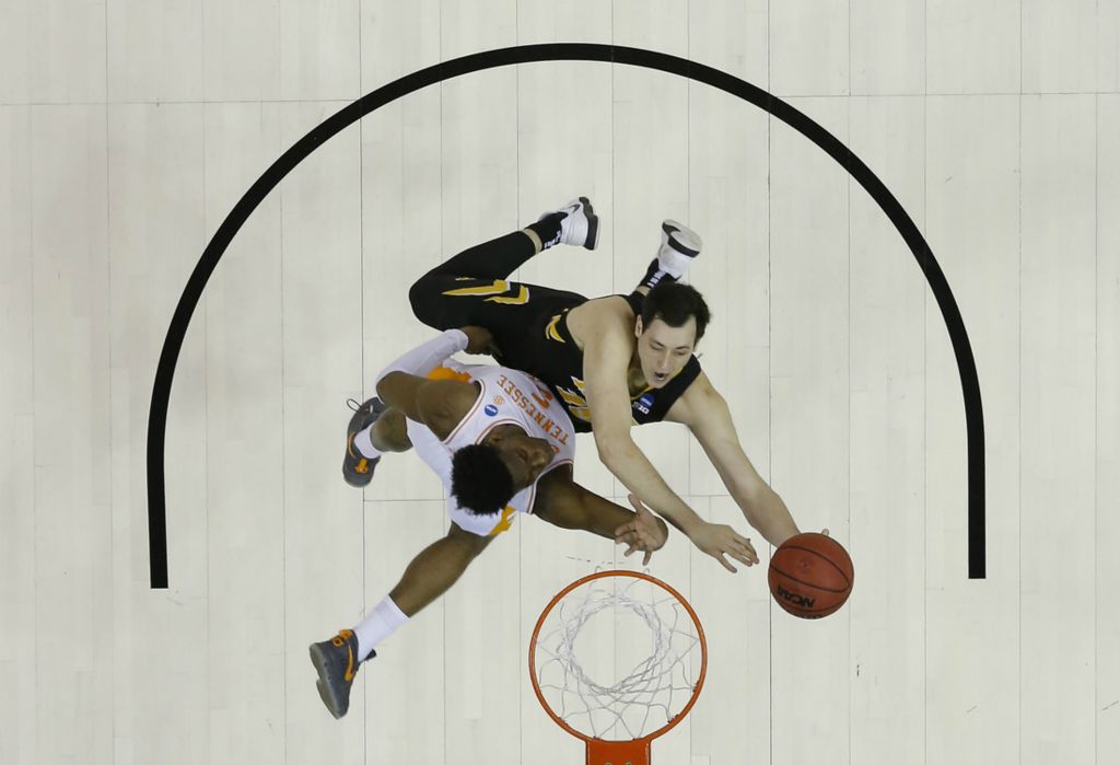 Third Place, Ron Kuntz Sports Photographer of the Year - Adam Cairns / The Columbus DispatchTennessee Volunteers guard Admiral Schofield (5) defends Iowa Hawkeyes forward Ryan Kriener (15) under the basket during the first half of the NCAA men's basketball tournament second-round game at Nationwide Arena in Columbus on March 24, 2019. 