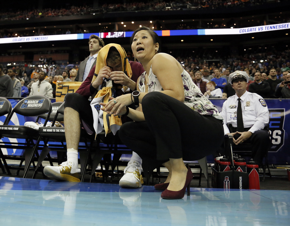 Third Place, Ron Kuntz Sports Photographer of the Year - Adam Cairns / The Columbus DispatchColgate Raiders athletic trainer Leslie Cowan gives forward Rapolas Ivanauskas the play-by-play during the second half of the NCAA men's basketball tournament first-round game at Nationwide Arena in Columbus on March 22, 2019. Ivanauskas could not play due to a severe eye irritation. Tennessee won 77-70. 