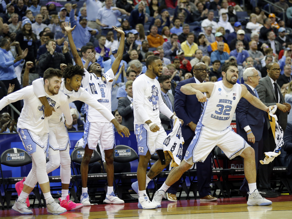 Third Place, Ron Kuntz Sports Photographer of the Year - Adam Cairns / The Columbus DispatchNorth Carolina Tar Heels forward Luke Maye (32) and the rest of the bench react to a dunk by forward Nassir Little (5) during the second half of the NCAA men's basketball tournament second-round game against the Washington Huskies at Nationwide Arena in Columbus on March 24, 2019. 