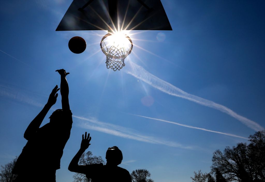 Award of Excellence, Ron Kuntz Sports Photographer of the Year - Kurt Steiss / The BladeKyrie Newall, 17, left, tosses the ball up for a layup as he's defended by Rico Newall, 16, both of Toledo, as they play a pick-up game of basketball at Jamie Farr Park in Toledo on Tuesday, April 16, 2019. 