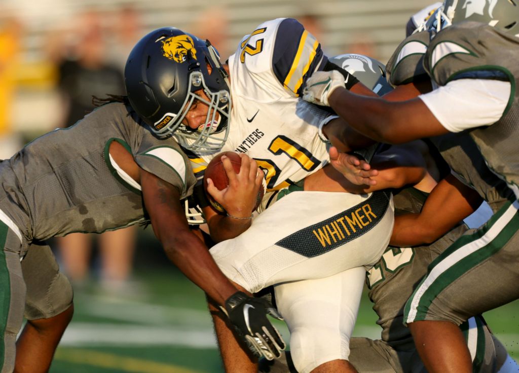 Award of Excellence, Ron Kuntz Sports Photographer of the Year - Kurt Steiss / The BladeWhitmer's Jared Banks (21) gets swarmed by Start defenders during a drive during a high school football game between Whitmer and Start at Start High School in Toledo on Thursday, Aug. 29, 2019.