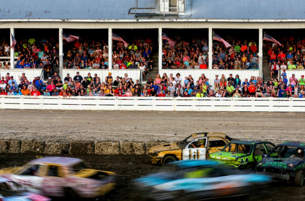 Award of Excellence, Ron Kuntz Sports Photographer of the Year - Kurt Steiss / The BladePeople watch from the grandstand during the demolition derby at the Henry County Fair in Napoleon, Ohio, on Thursday, Aug. 15, 2019. 