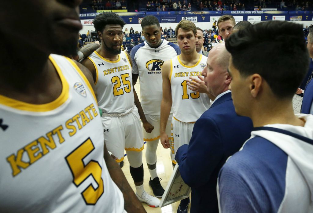 First Place, Sports Picture Story - Jeff Lange / Akron Beacon Journal, “Athlete With Autism”Freshman center Kalin Bennett, center, joins his teammates in a huddle to listen to Coach Rob Senderoff go over the game plan before Kent State's season opener against the Hiram College Terriers at the MAC Center, Wednesday, Nov. 6, 2019, in Kent, Ohio.