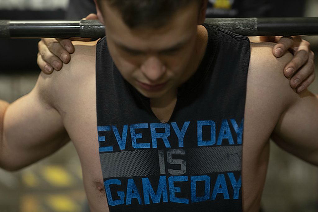 Second Place, Sports Picture Story - Joshua A. Bickel / The Columbus Dispatch, “Garrett’s Big Lift”Trainer Thomas Covert checks the positioning of Garrett’s shoulders while spotting him as he back squats on Wednesday, February 27, 2019 at Old School Gym in Pataskala, Ohio.