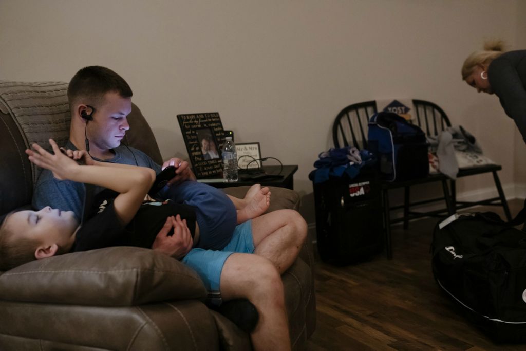 Second Place, Sports Picture Story - Joshua A. Bickel / The Columbus Dispatch, “Garrett’s Big Lift”Garrett Ford sits with little brother, Connor, as the pair watch videos while Leah finishes packing Garrett's luggage the night before his trip to Abu Dhabi for the Special Olympics World Games on Tuesday, March 5, 2019 at his home in Pataskala, Ohio.