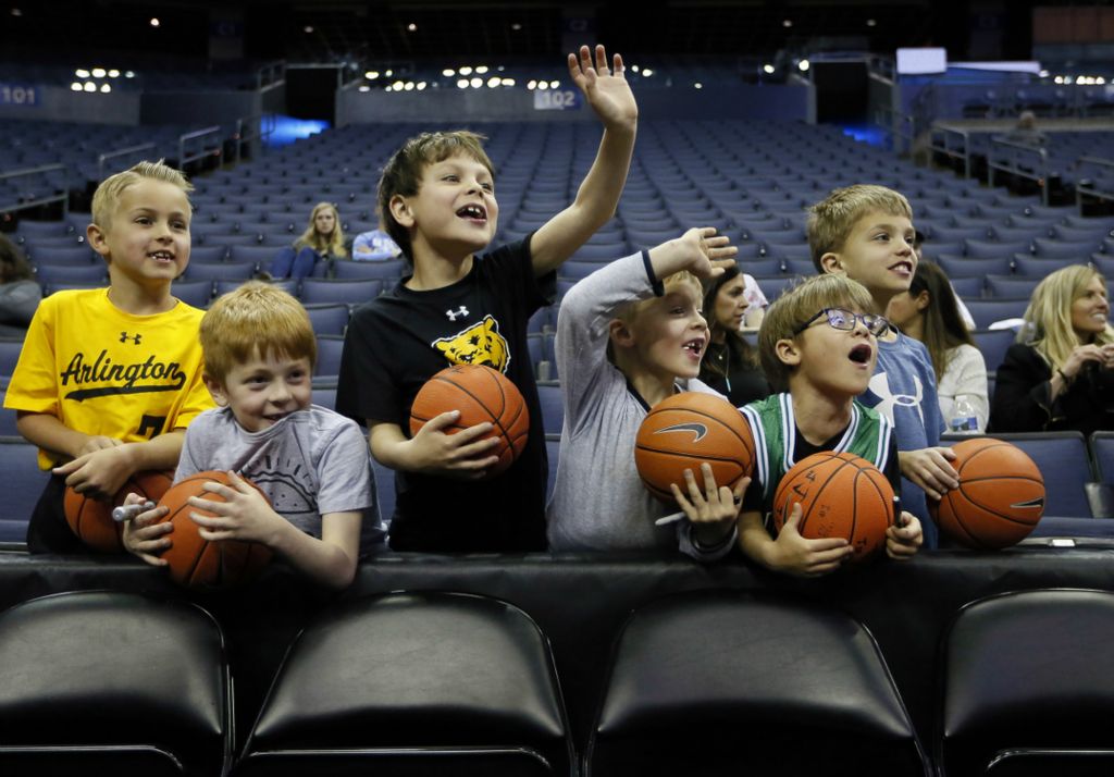 Award of Excellence, Sports Picture Story - Adam Cairns / The Columbus Dispatch, “March Madness”Schoolmates at Barrington Elementary in Upper Arlinton, from left, Shep Rigo, 7, Calvin Clark, 7, Lucas Boe, 7, Brooks Simon, 5, Cole Boe, 5, and AJ Simon, 7, motion to Utah State players during practice day for fans prior to the start of the first and second rounds of the NCAA men's basketball tournament at Nationwide Arena in Columbus on March 21, 2019. Eventually Utah State Aggies center Neemias Queta came over to sign autographs on their miniature basketballs. 