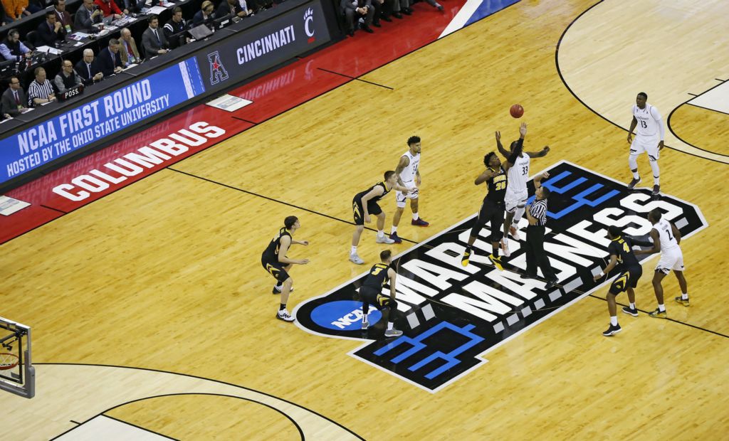 Award of Excellence, Sports Picture Story - Adam Cairns / The Columbus Dispatch, “March Madness”Cincinnati Bearcats center Nysier Brooks (33) and Iowa Hawkeyes forward Tyler Cook (25) take the opening tip-off during NCAA men's basketball tournament first-round game at Nationwide Arena in Columbus on March 22, 2019. 