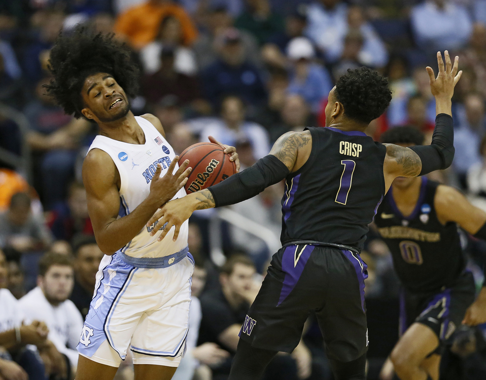 Award of Excellence, Sports Picture Story - Adam Cairns / The Columbus Dispatch, “March Madness”North Carolina Tar Heels guard Coby White (2) steals the ball from Washington Huskies guard David Crisp (1) during the second half of the NCAA men's basketball tournament second-round game at Nationwide Arena in Columbus on March 24, 2019. 