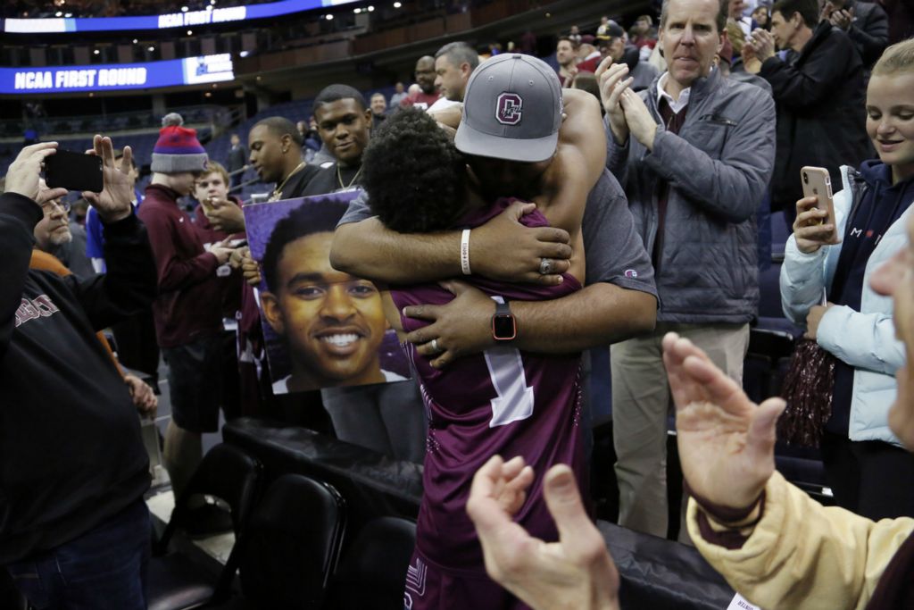 Award of Excellence, Sports Picture Story - Adam Cairns / The Columbus Dispatch, “March Madness”Colgate Raiders guard Jordan Burns (1) hugs his dad, Eroy Burns of San Antonio, Texas, following the NCAA men's basketball tournament first-round game against the Tennessee Volunteers at Nationwide Arena in Columbus on March 22, 2019. Tennessee won 77-70. Burns had 32 points in the loss.  