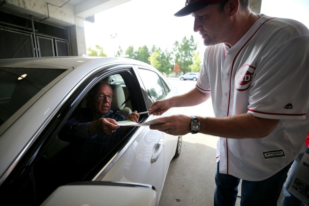 Third Place, Sports Picture Story - Kareem Elgazzar / The Cincinnati Enquirer, “Marty Brennaman's Last Day”Cincinnati Reds Hall of Fame broadcaster Marty Brennaman signs autographs for fans as he enters the parking garage on his last day before he retires after 46 years in the booth, Thursday, Sept. 26, 2019, at Great American Ball Park in Cincinnati. 
