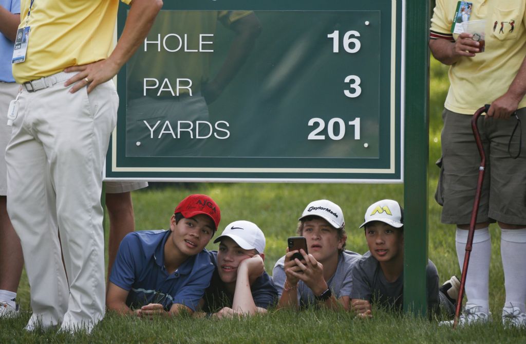First Place, Team Picture Story - Joshua A. Bickel / The Columbus Dispatch, “Memorial Golf Tournament”Young fans watch action from the 16th tee during the final round of the Memorial Tournament on Sunday, June 2, 2019 at Muirfield Village Golf Club in Dublin. 