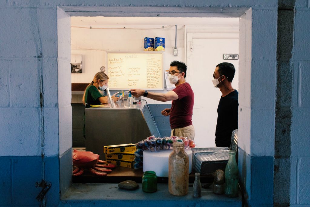 First Place, Chuck Scott Student Photographer of the Year - Carlin Stiehl / Ohio UniversityJozie Wilson works the storefront at Wittman Wharf Seafood in Wittman. The company opened a storefront at its shucking house location in response to Covid-19, as restaurant closures hurt their business profits. The move was a success, as news of the store spread to the local community and calls started coming from states as far away as New York according to Marc Van Pelt, a partner in the business.