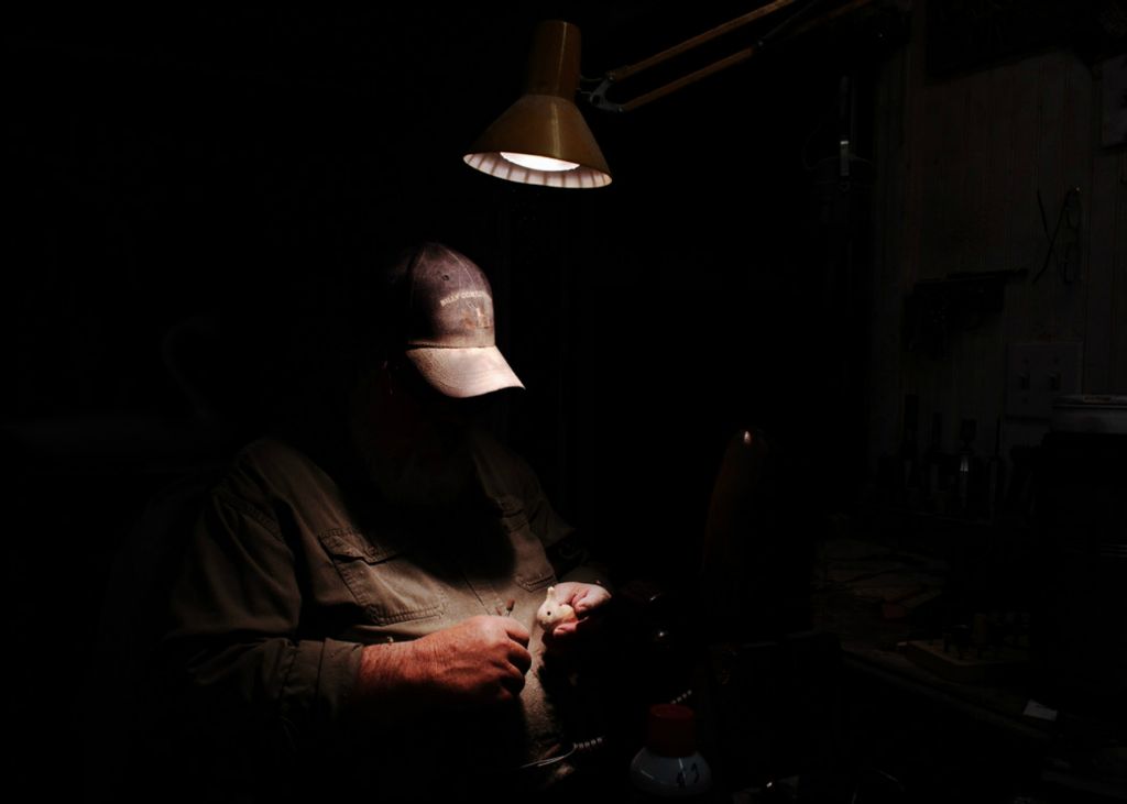 First Place, Chuck Scott Student Photographer of the Year - Carlin Stiehl / Ohio UniversityMaster carver Capt. Bill Collins works on a miniature carving in his workshop in Cernetville Mound, Md. on October 16, 2020. Collins apprenticed under Madison Mitchell who defined the Havre de Grace style of decoy.
