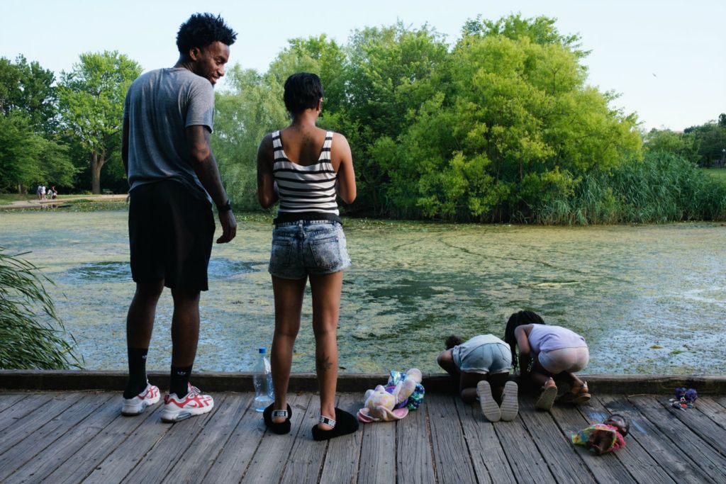 First Place, Chuck Scott Student Photographer of the Year - Carlin Stiehl / Ohio UniversityBradford Buchana along with his girlfriend Shemiah Bobbitt and two cousins, (left) Dior Torris, 5, and Karter Sims, 4, look for turtles and koi fish on the boardwalk at the Friends of Patterson Park in Baltimore Md. on June 10, 2020. Buchana loves the park because “a lot of people in urban communities get to see nature.” After converting to veganism six years ago, he emphasizes the importance of the relationship between humans and the environment, especially in green spaces like the park. “The beauty of mother nature, animals, [it’s] almost like the zoo is in the grasp of your hands… they’re (animals) our neighbors. All the creatures play a big part in the ecosystem,” says Buchana.  