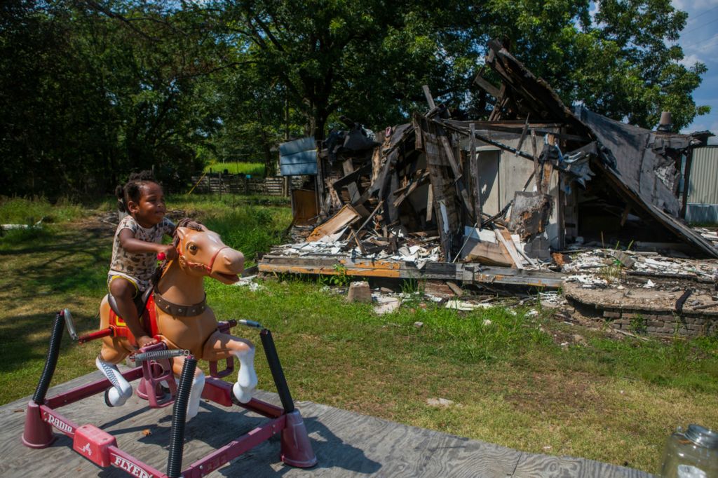 Second Place, Chuck Scott Student Photographer of the Year - Michael Blackshire / Ohio UniversityKiray rides a mechanical horse outside of her Grandmothers trailer home in Itta Bena, Mississippi on August 9th, 2020. In rural Mississippi, house that have been demolished over the years remain in the same neighborhoods. 